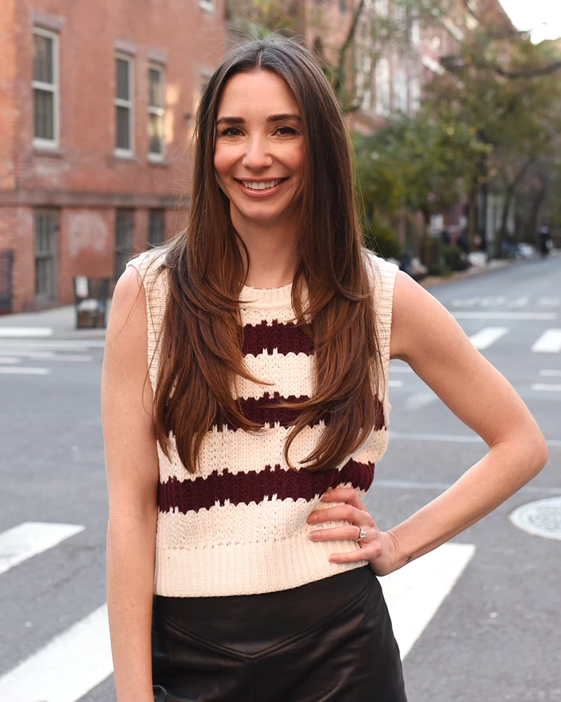 Photo fo Blaine in a striped sweater, at an intersection in Greenwich Village