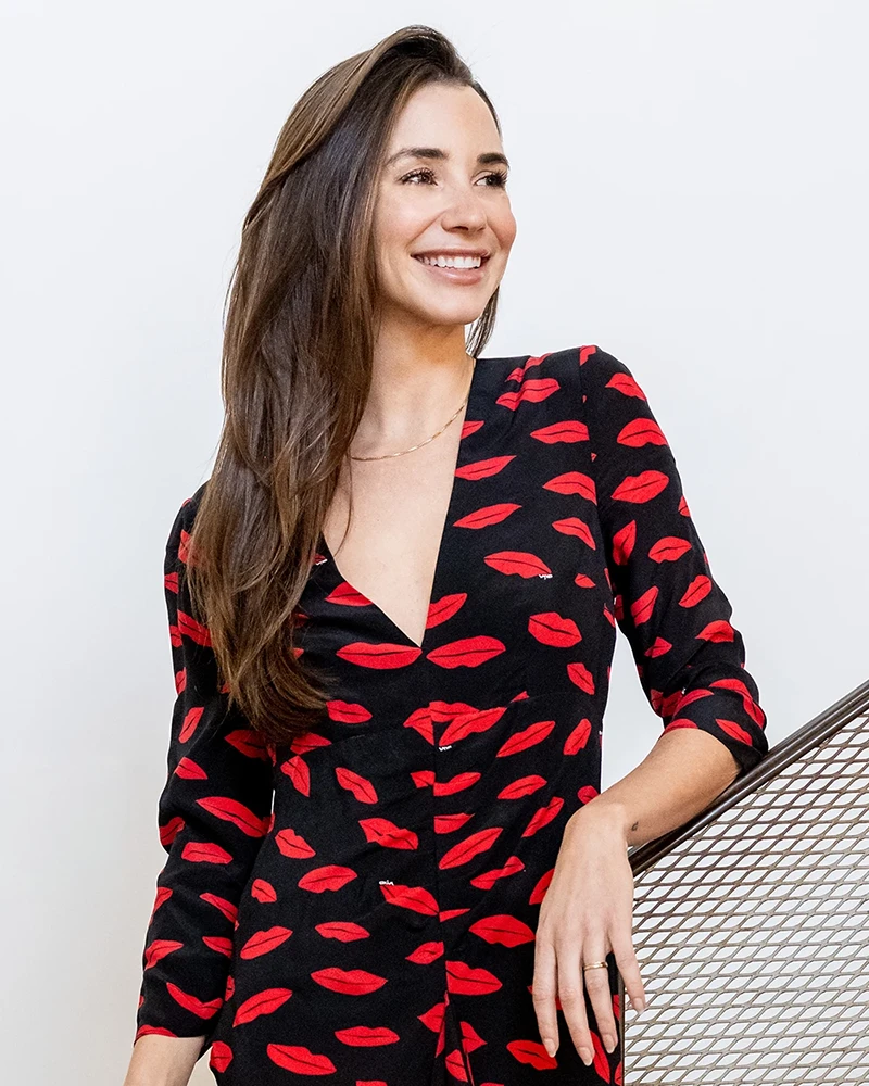 Photo of dating coach Blaine Anderson in a black dress with a red lip print